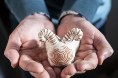 ceramic-artist-jon-williams-holding-a-bug-rattle