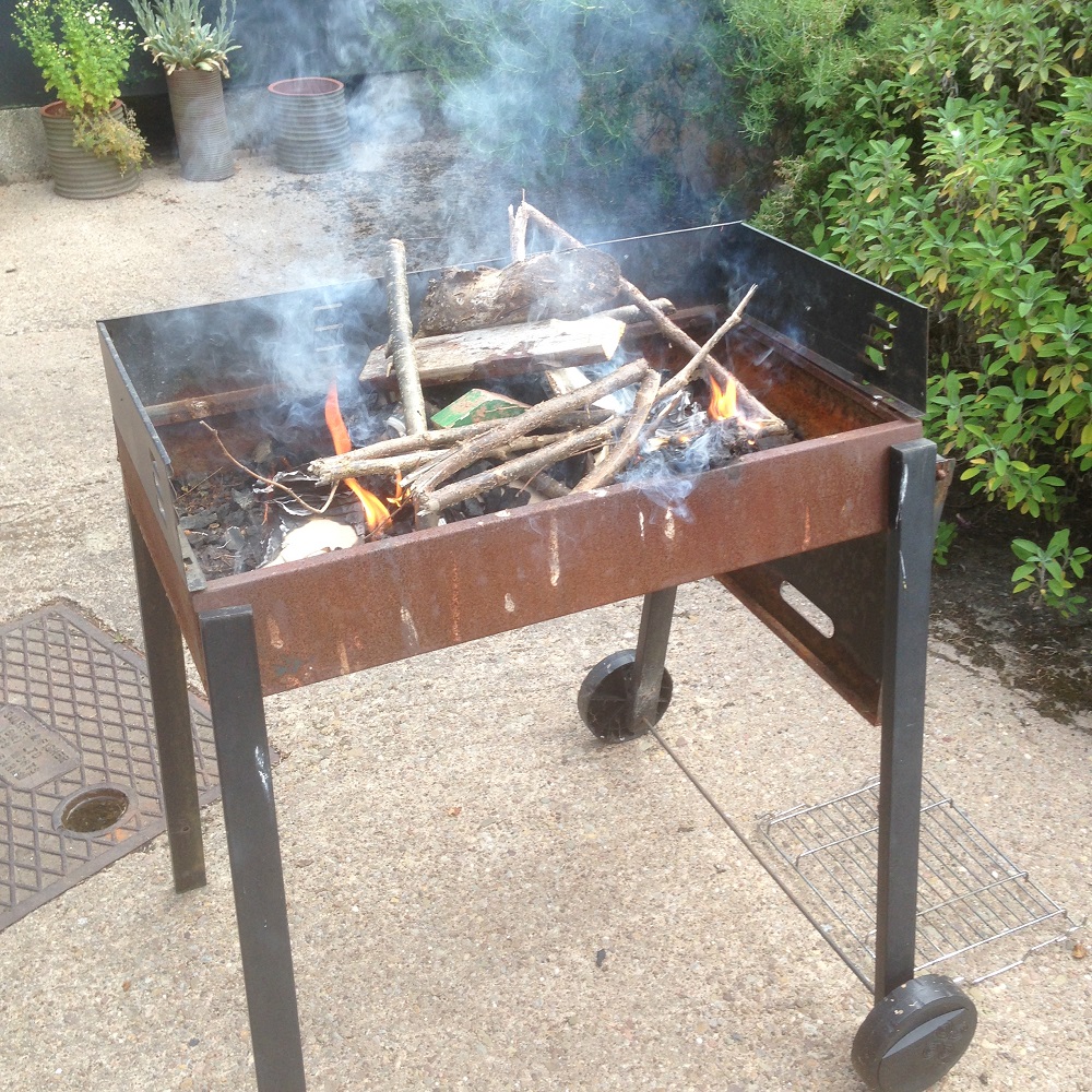 garden bbq filled with ceramic experiments by artist jon williams