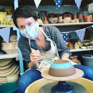 a masked pottery weekend course participant at eastnor pottery