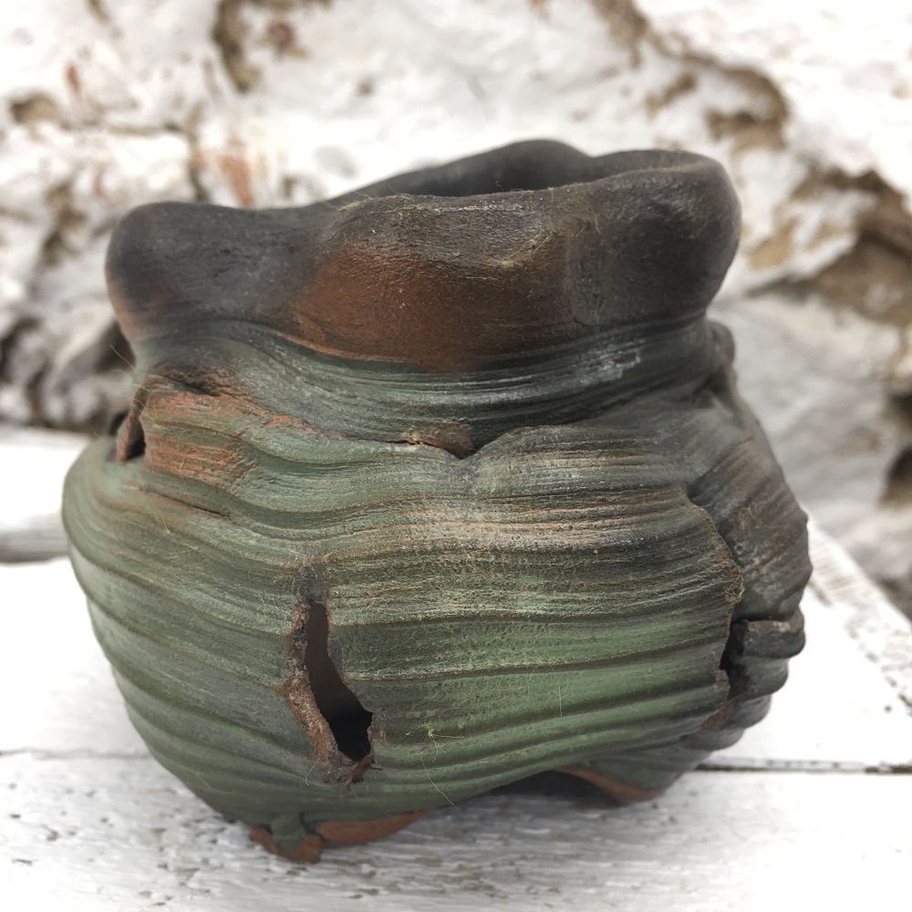 smoke fired thrown torn and altered pot made on the potter's wheel by ceramic artist jon williams
