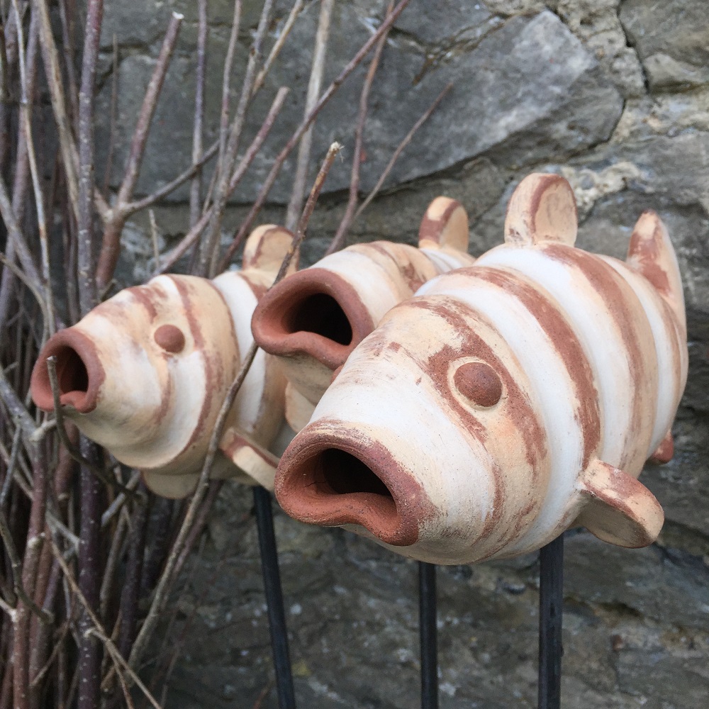 three pottery fish on metal rods by herefordshire artist jon williams