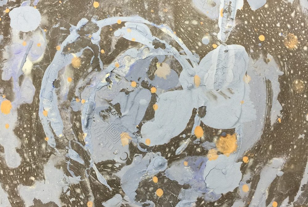 splats of coloured pottery slip look like a galaxy of stars and black holes